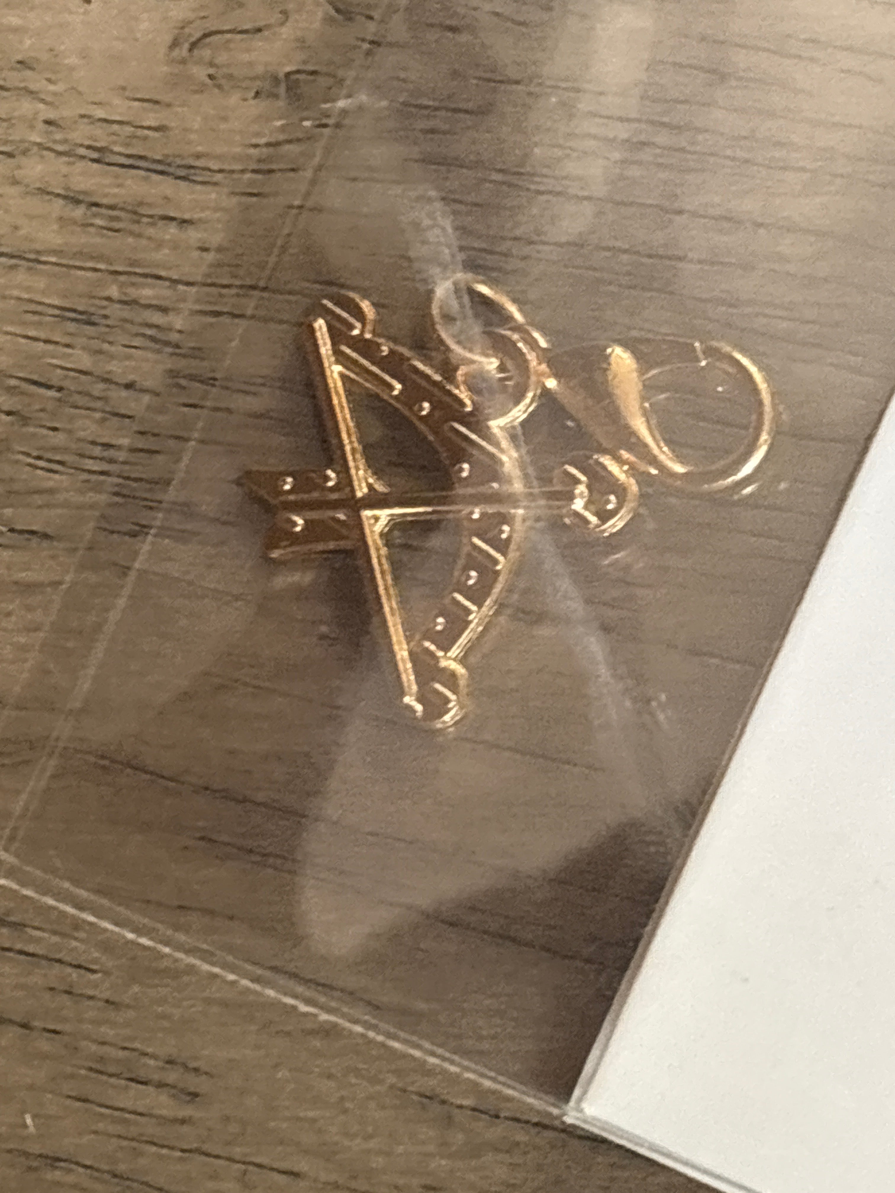 Gold bow and arrow charm