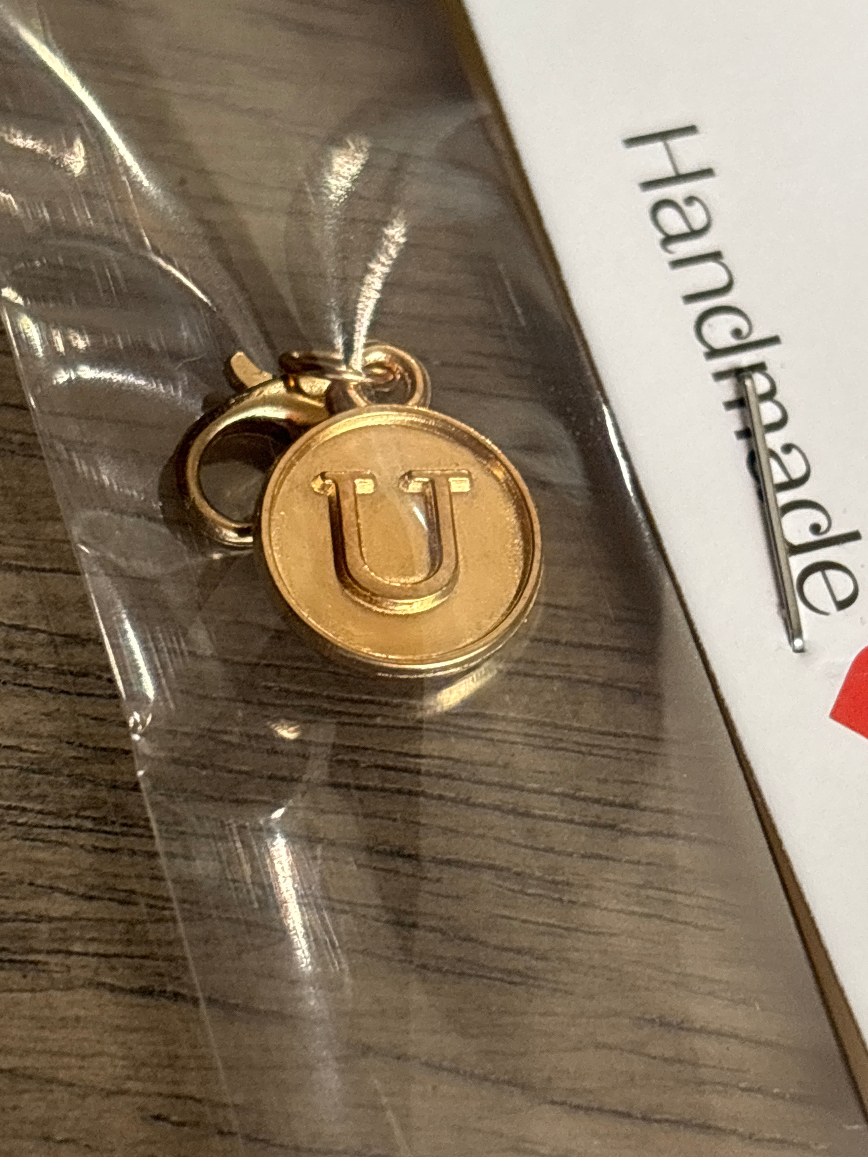 Gold U charm