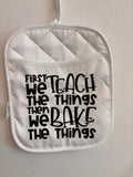 First We Teach then we Bake the things Hot Pad
